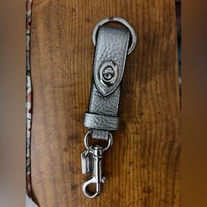 Coach Metallic Silver Turnlock Keychain